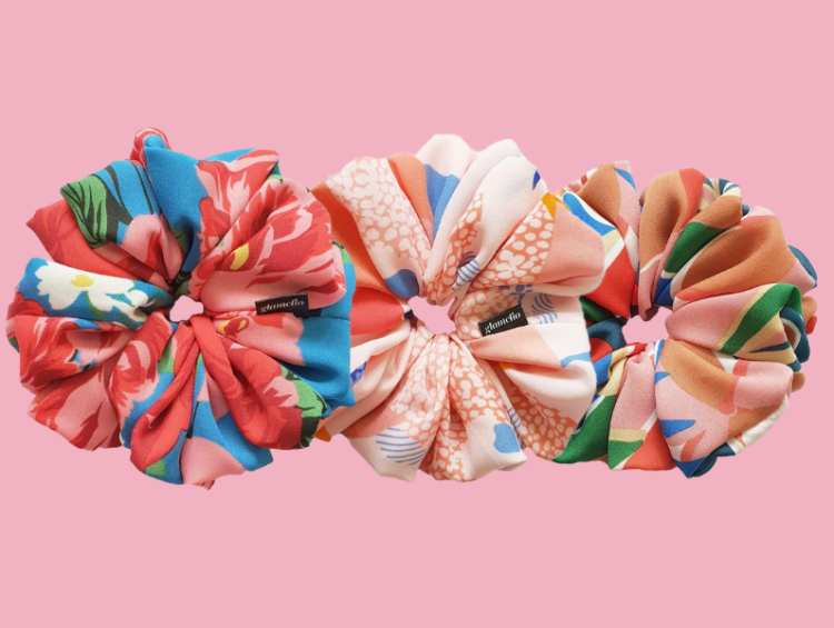 Why Satin Handmade Scrunchies are Better: Glamclio 1 a group of hair scrunffs on a pink background