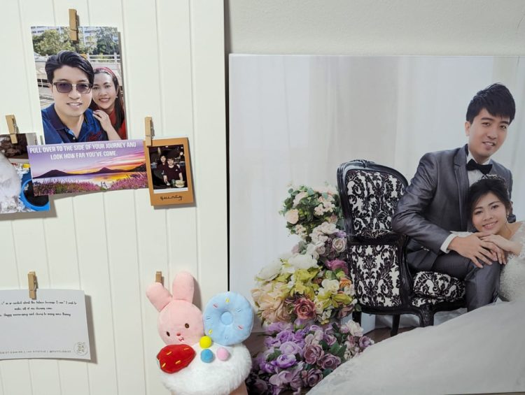 How to Upcycle an Old Cabinet Door into a DIY Photo Display Board 1 a couple is posing for a picture in their wedding photo booth