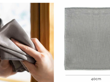 a person holding a cloth over a window sill