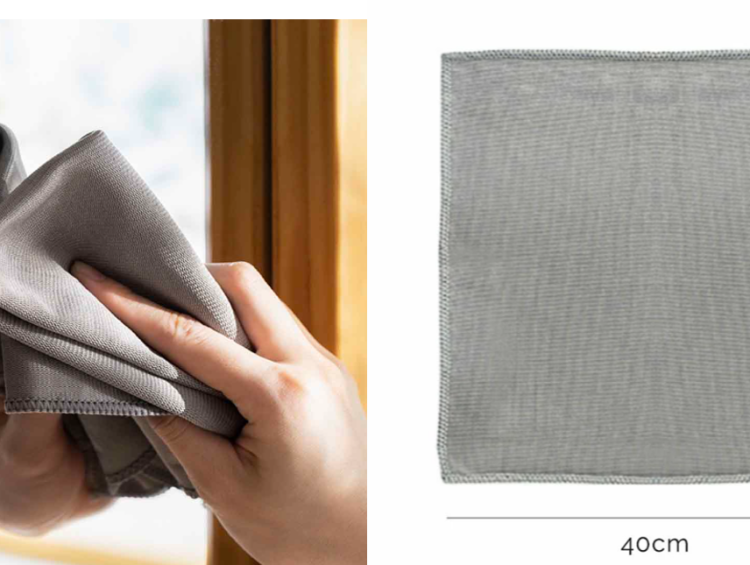 What is the Best Cloth for Cleaning Glass and Mirrors 1 a person holding a cloth over a window sill