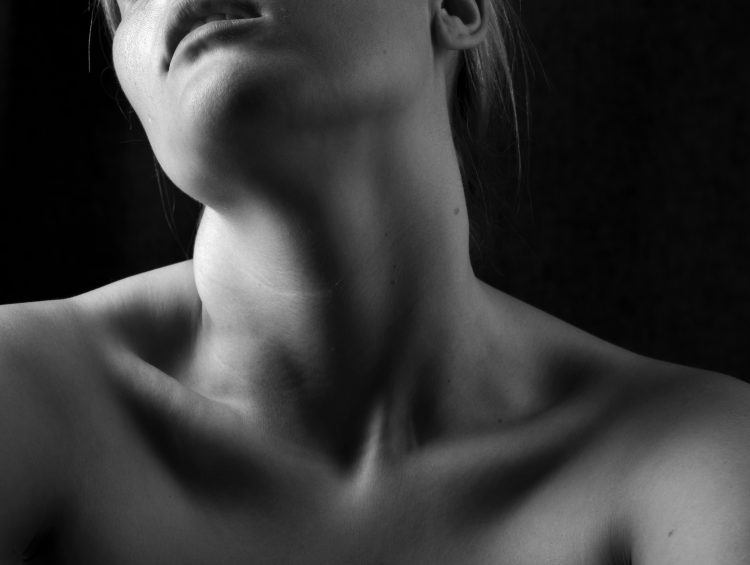 Why is a heating pad good for shoulder pain? 1 black and white photograph of a woman with no shirt on