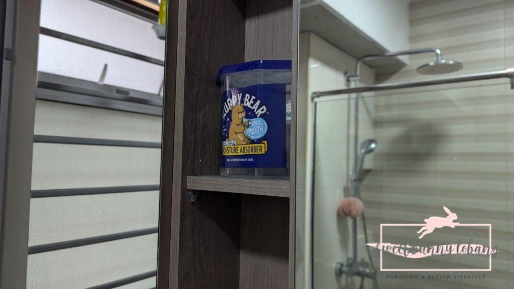 a slurpy bear container on a shelf  in a bathroom