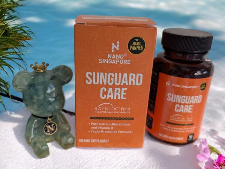 Achieve Flawless Skin in the Digital Age with Sunguard Care Oral Sunblock* 1 a bottle of Sunguard care nano singapore and a small animal figure next to a box