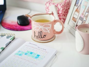 Desk with laptop mug and cute pink items