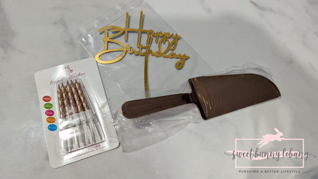 gold happy birthday sign , candles and knife