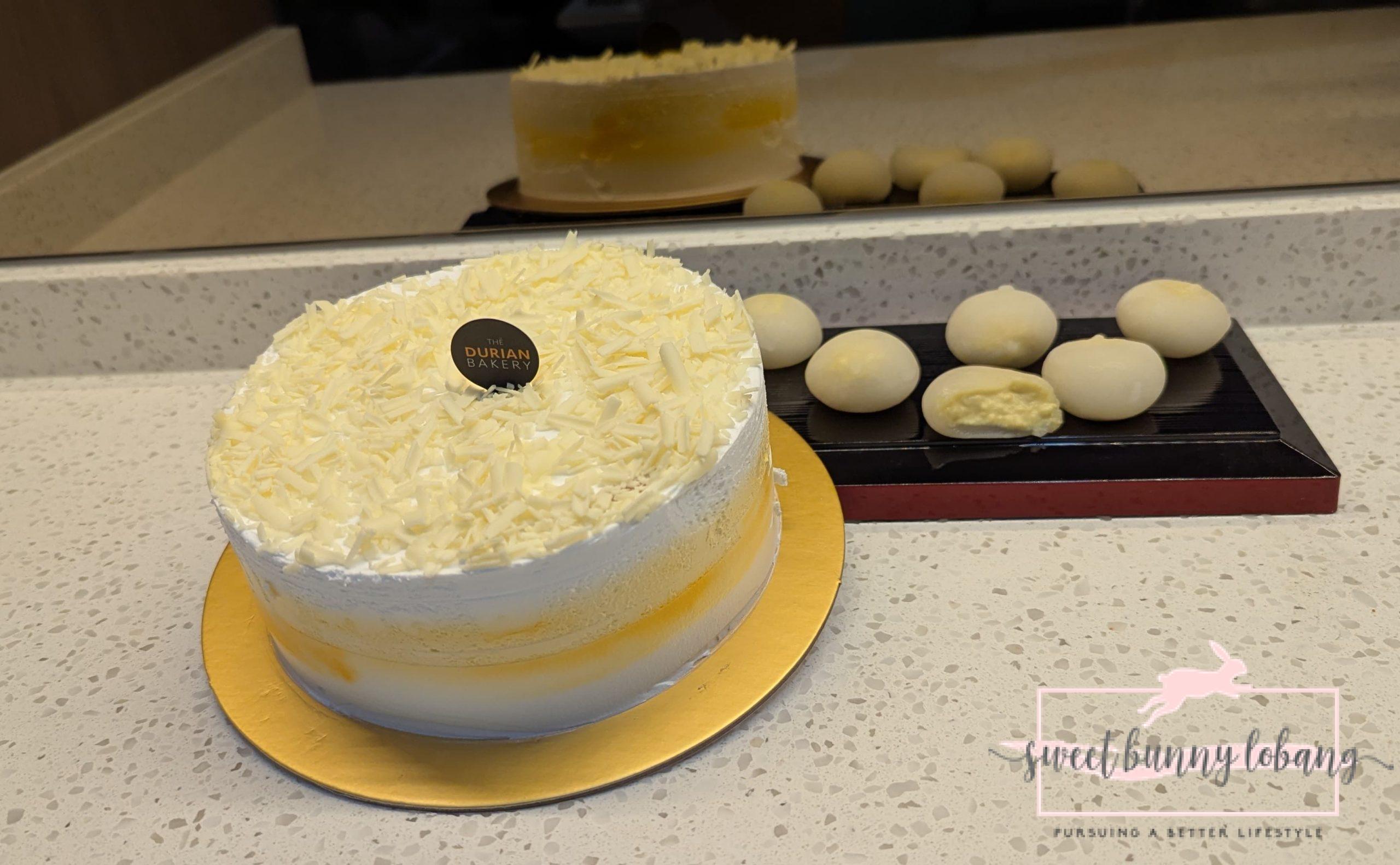 A beautifully frosted white cake from The Durian Bakery, featuring a pristine white exterior.